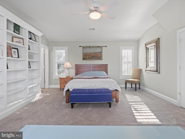 bedroom with multiple windows, carpet, ceiling fan, and vaulted ceiling