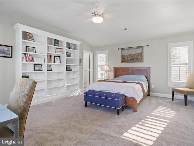 bedroom featuring ceiling fan, vaulted ceiling, and light colored carpet