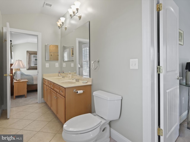 bathroom with tile patterned flooring, toilet, vanity, a notable chandelier, and lofted ceiling