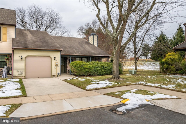 view of front of property with a lawn and a garage