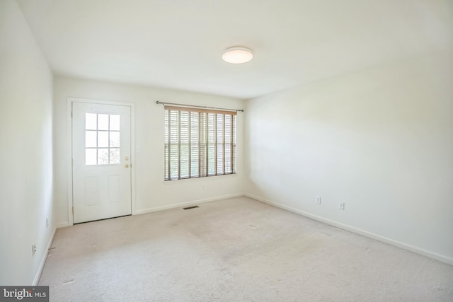 empty room featuring light colored carpet