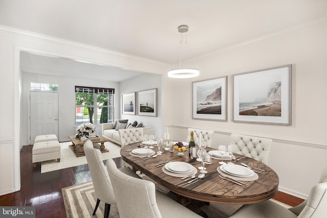 dining area featuring crown molding and dark hardwood / wood-style floors