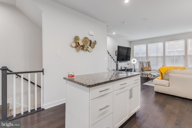 kitchen with dark stone countertops, dark wood-type flooring, open floor plan, and recessed lighting