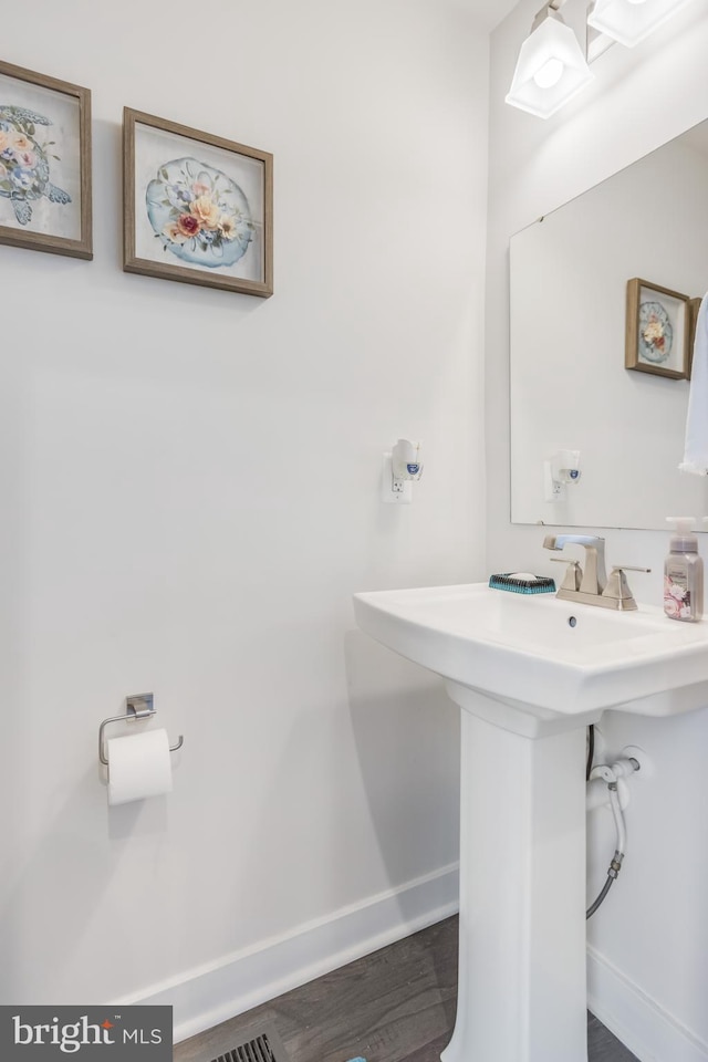 bathroom featuring wood finished floors and baseboards