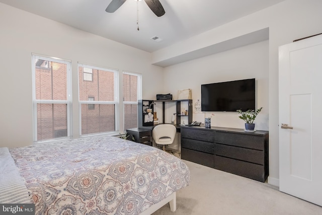 carpeted bedroom with visible vents and ceiling fan