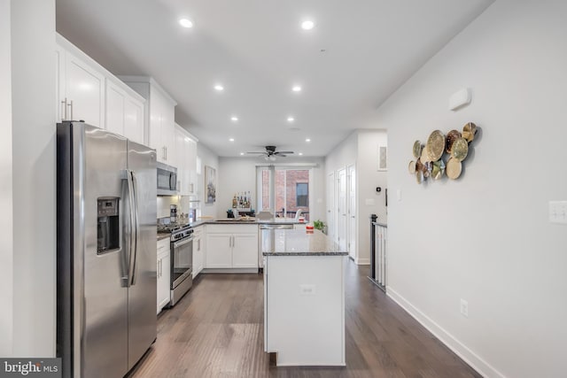 kitchen featuring a peninsula, white cabinets, recessed lighting, and appliances with stainless steel finishes