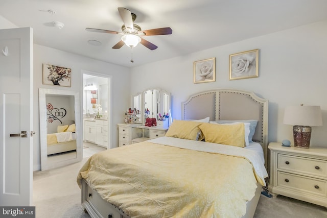 bedroom featuring connected bathroom, light colored carpet, and ceiling fan