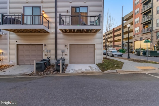 exterior space with central AC and an attached garage