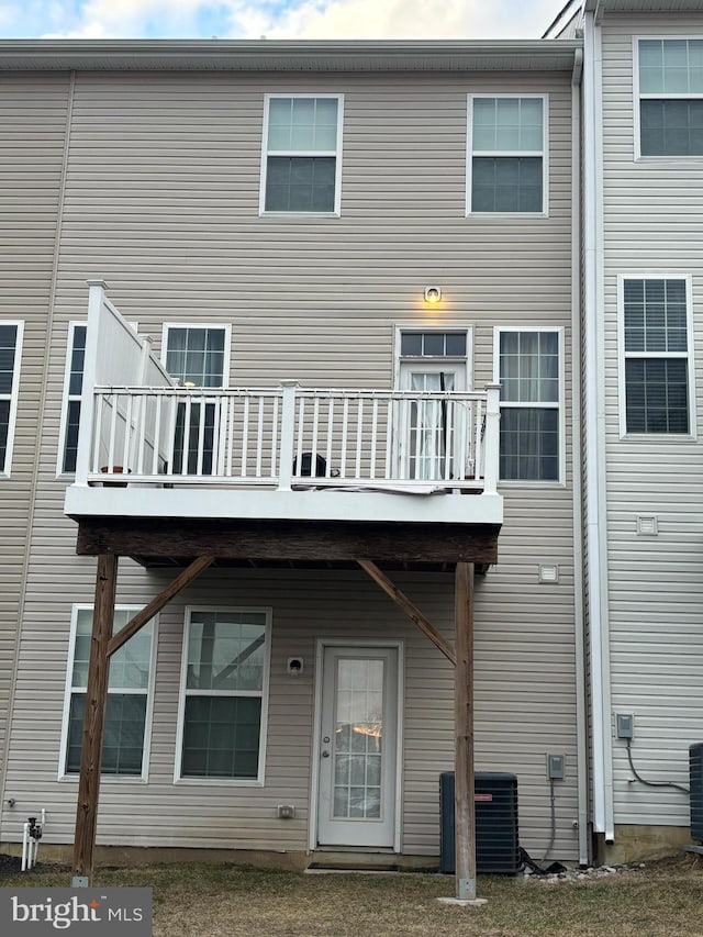 rear view of property featuring cooling unit