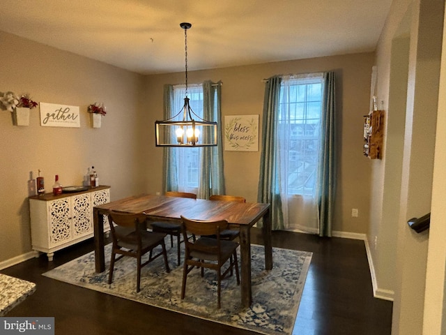 dining space featuring a notable chandelier and dark hardwood / wood-style floors