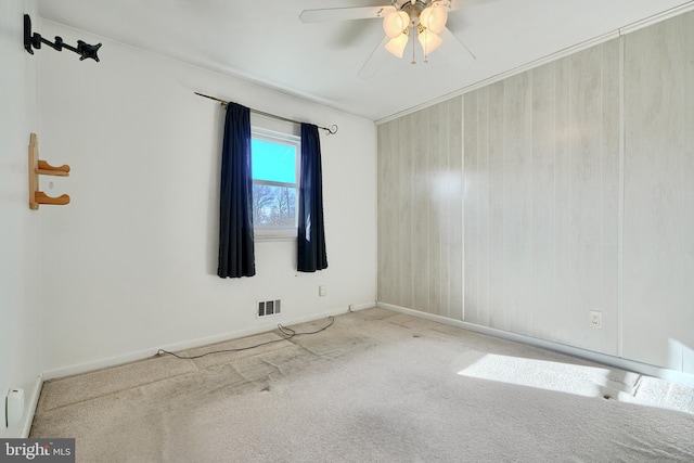 unfurnished room featuring ceiling fan and light carpet