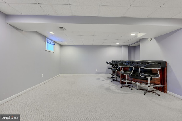 interior space featuring a paneled ceiling and carpet