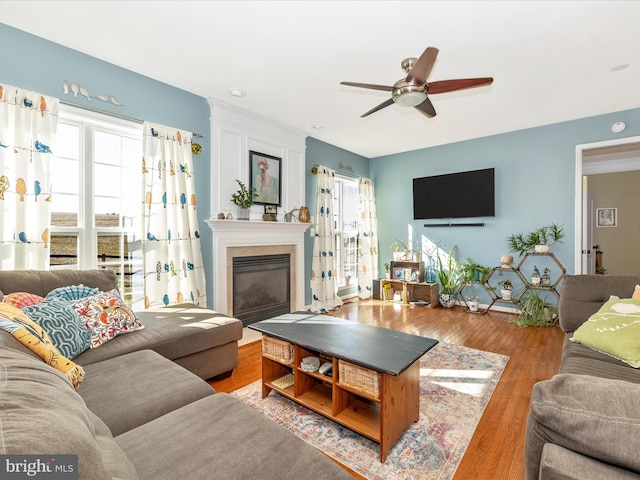 living room featuring hardwood / wood-style floors and ceiling fan