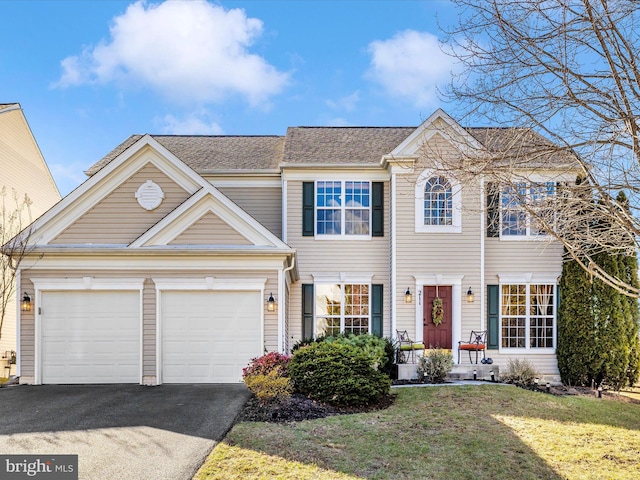 view of front facade with a garage and a front lawn