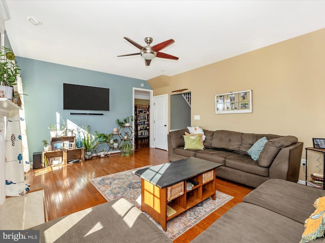 living room featuring hardwood / wood-style floors and ceiling fan