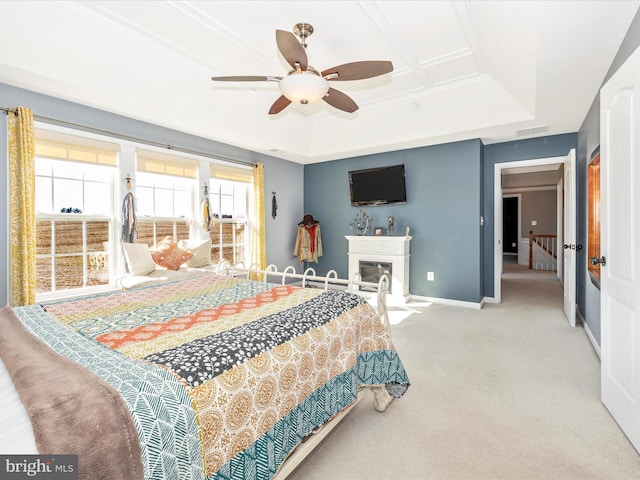 bedroom featuring crown molding, light colored carpet, a raised ceiling, and ceiling fan