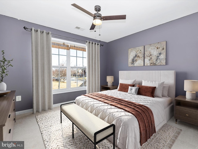 bedroom featuring ceiling fan and light carpet