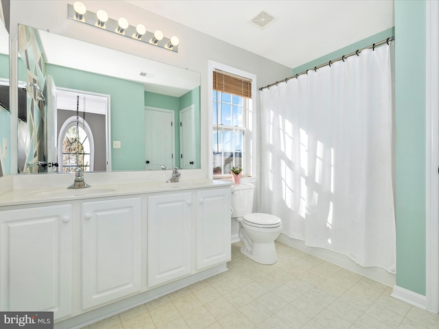 full bathroom with vanity, toilet, and shower / bath combo with shower curtain