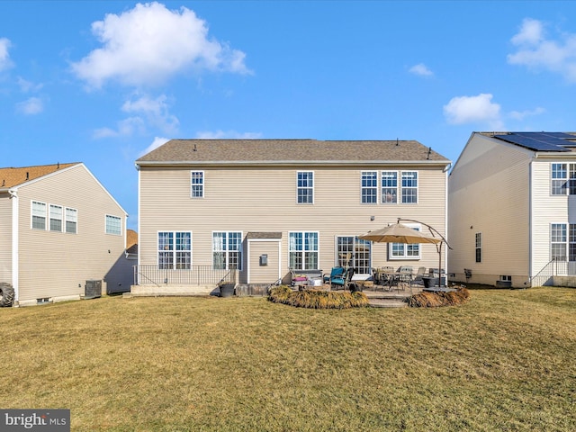 rear view of house with central AC unit, a patio, and a lawn