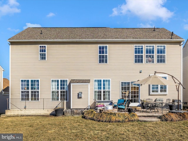 back of house featuring a yard and a patio area