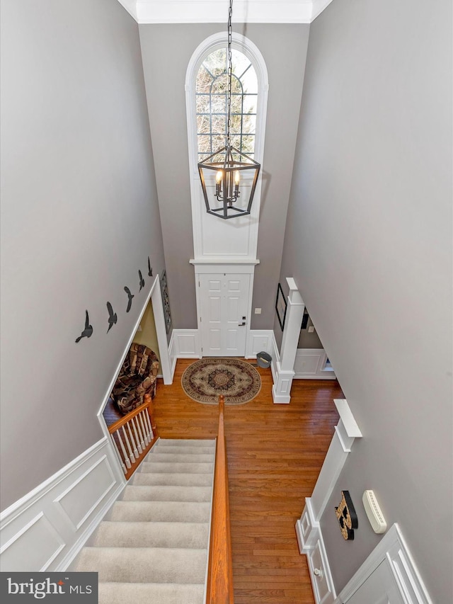 foyer entrance featuring a notable chandelier and wood-type flooring