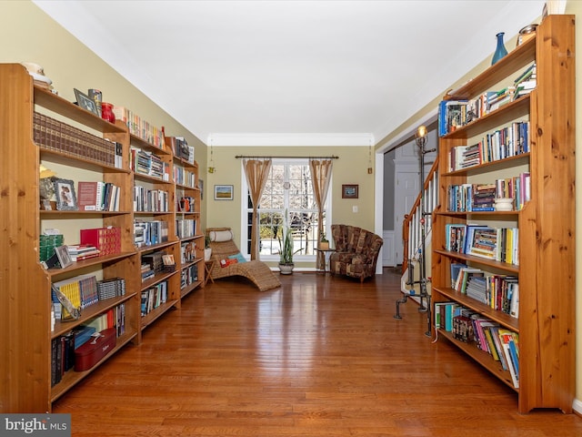 living area with ornamental molding and wood-type flooring