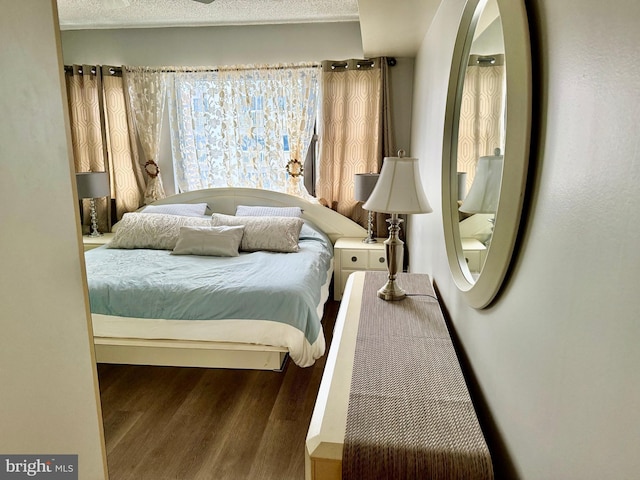 bedroom featuring a textured ceiling and wood-type flooring