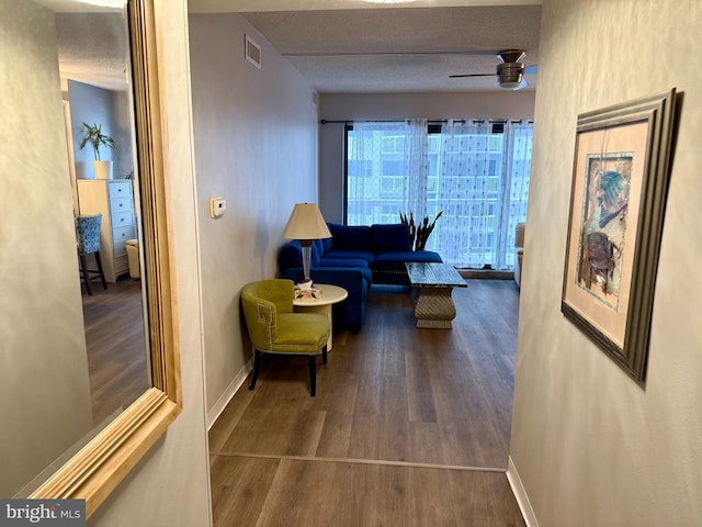 hallway featuring a textured ceiling and dark wood-type flooring