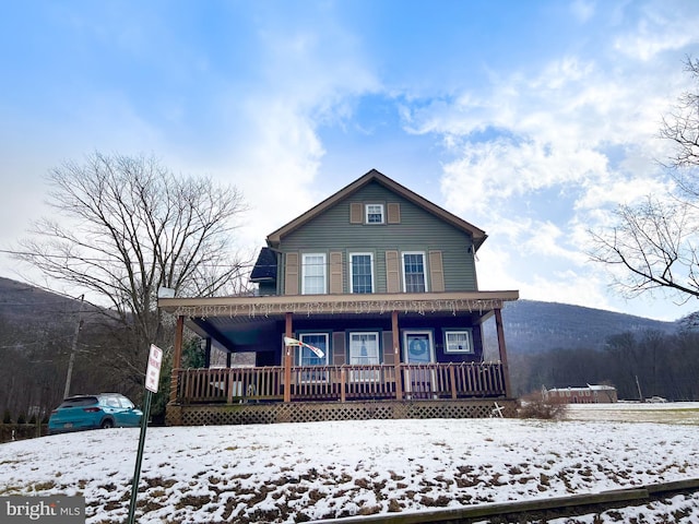 view of front facade with a mountain view and covered porch