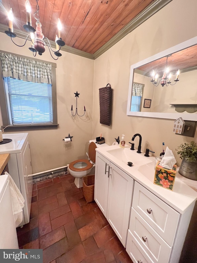 bathroom featuring washing machine and clothes dryer, an inviting chandelier, toilet, wood ceiling, and ornamental molding