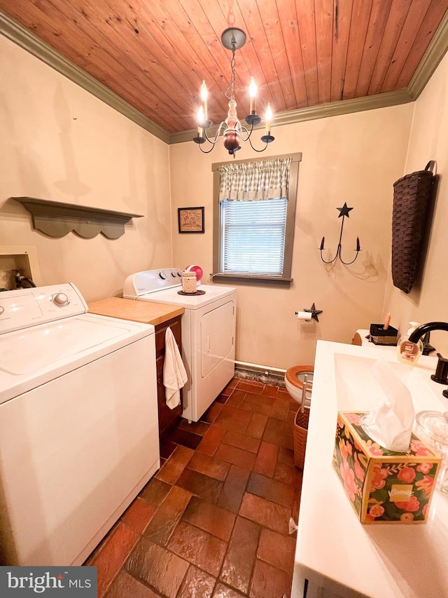 clothes washing area with wooden ceiling, an inviting chandelier, sink, ornamental molding, and washing machine and clothes dryer