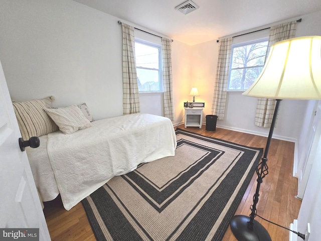 bedroom with hardwood / wood-style floors