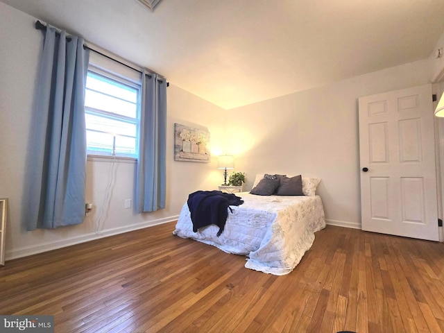 bedroom with dark hardwood / wood-style floors