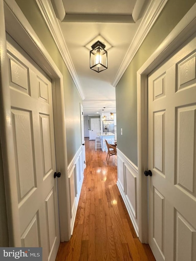 corridor featuring hardwood / wood-style floors and ornamental molding