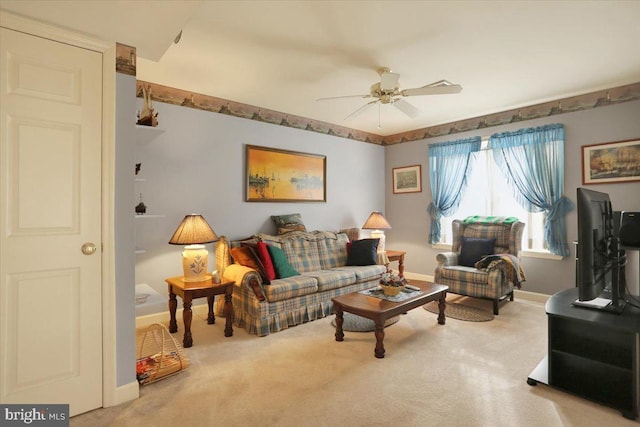 carpeted living room with ceiling fan