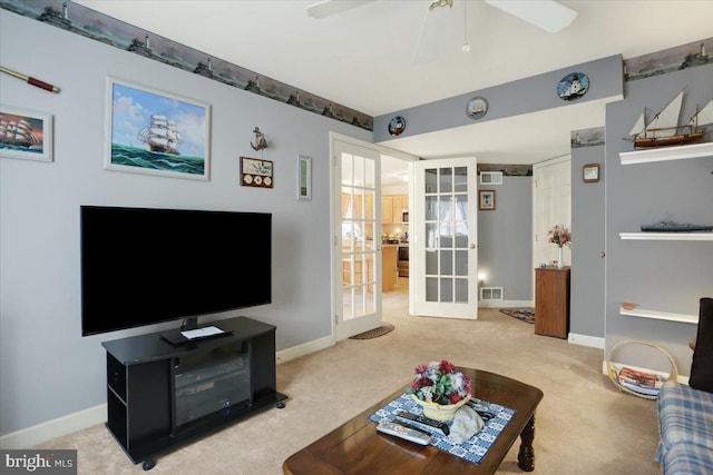 carpeted living room featuring french doors and ceiling fan