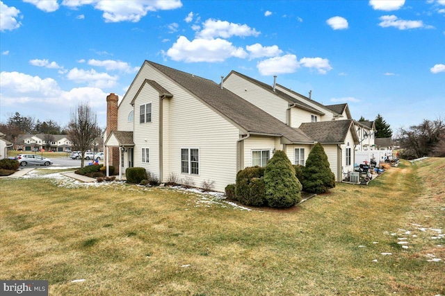 view of side of property with a lawn