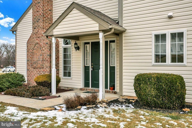 view of snow covered property entrance