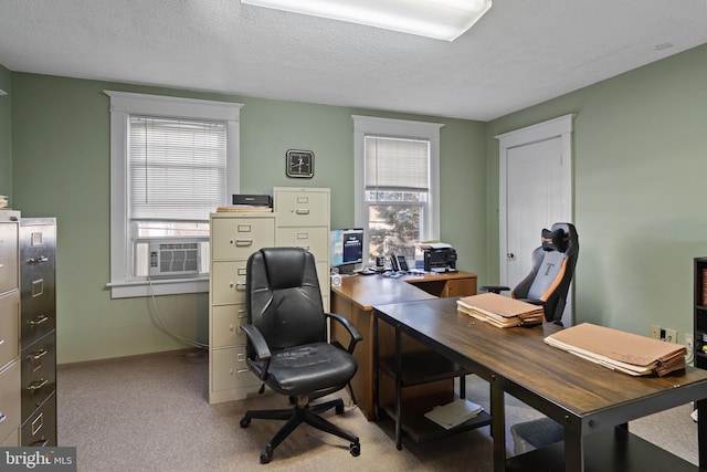 office space with plenty of natural light, cooling unit, light colored carpet, and a textured ceiling