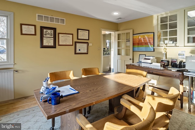 office space with radiator heating unit and light hardwood / wood-style flooring