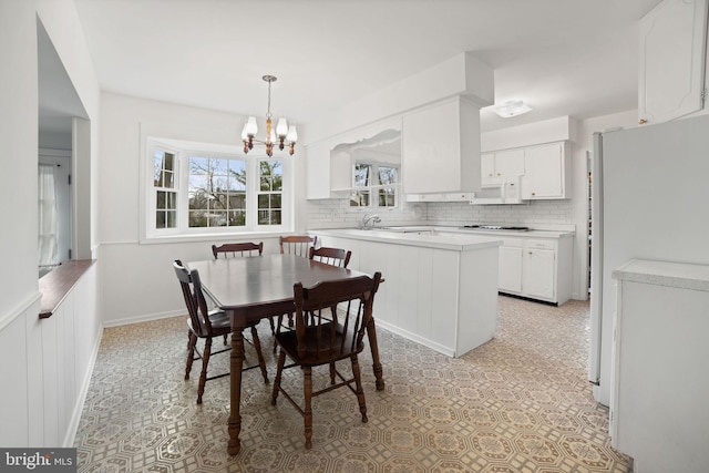 dining area featuring a notable chandelier