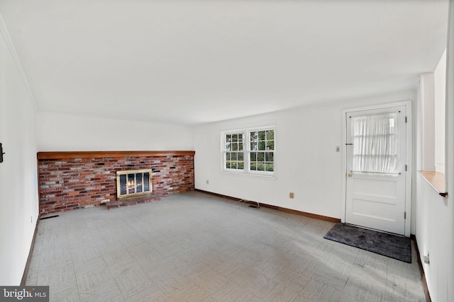 unfurnished living room featuring a brick fireplace