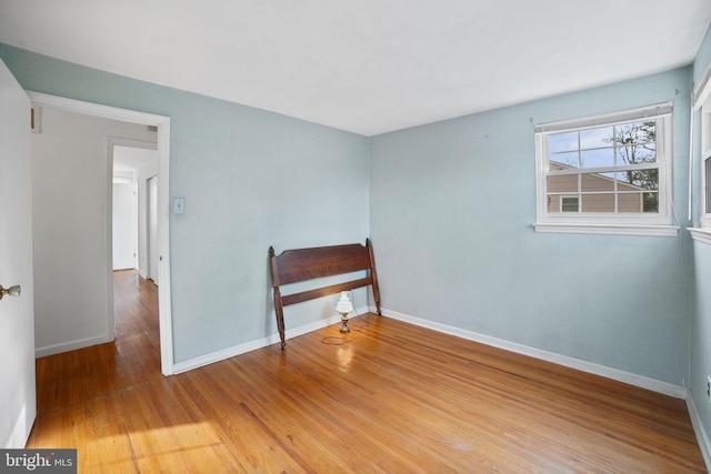 unfurnished room with hardwood / wood-style floors