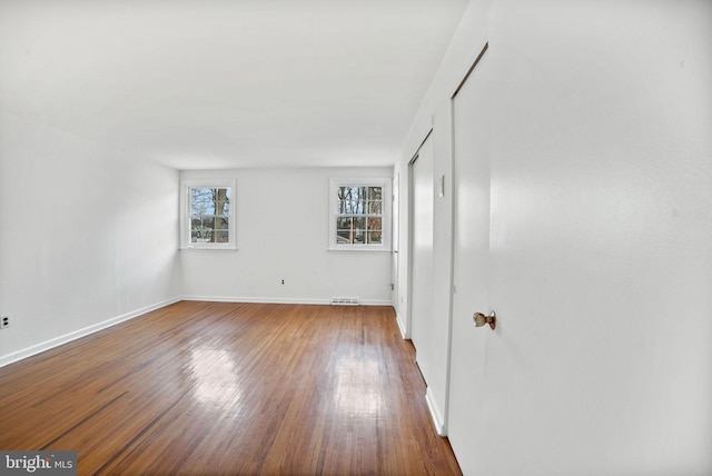 unfurnished room with wood-type flooring