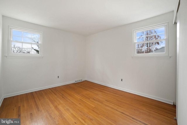 empty room with light hardwood / wood-style floors