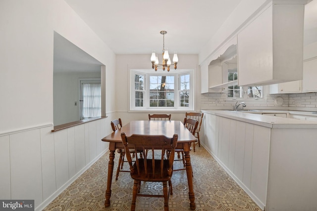 dining area with an inviting chandelier and sink