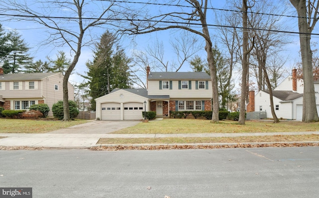 view of front of property featuring a front yard and a garage