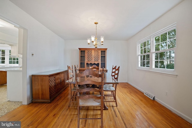 dining room featuring an inviting chandelier and hardwood / wood-style flooring