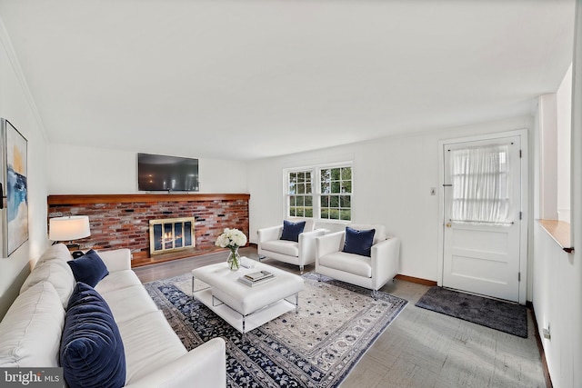 living room featuring a brick fireplace