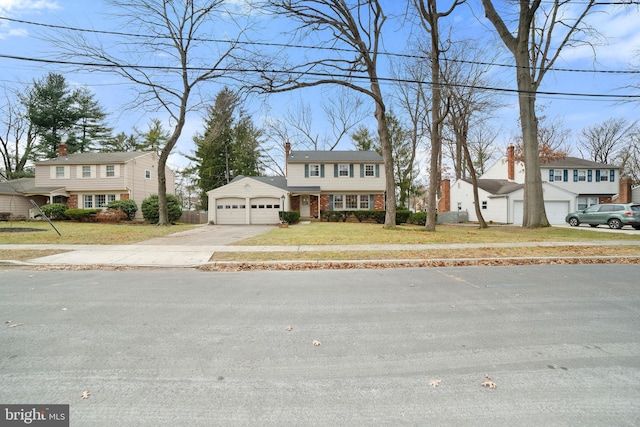 view of front of house with a garage and a front yard